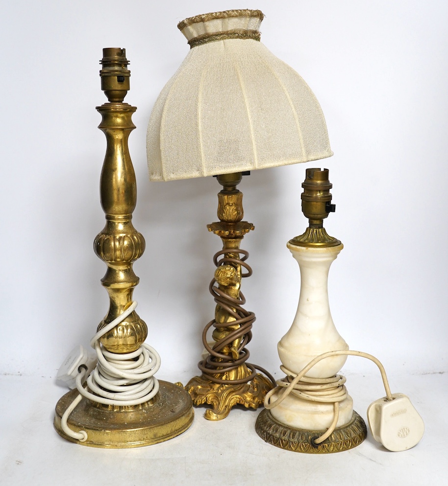 A figurative gilt metal table lamp, five brass table lamps and an alabaster lamp, tallest 35cm high. Condition - one poor, the others fair to good